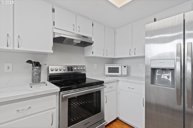 kitchen with light stone counters, stainless steel appliances, and white cabinets