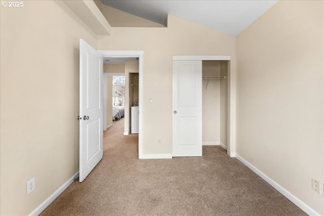 unfurnished bedroom featuring light carpet, lofted ceiling, and a closet