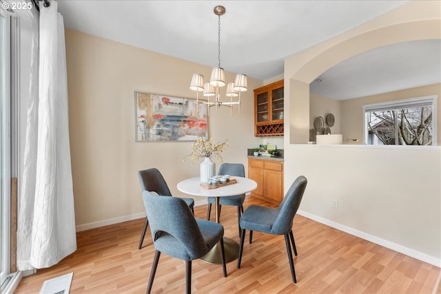 dining room with an inviting chandelier and light wood-type flooring