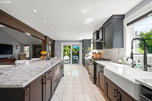 14510 NE 50th St, Vancouver, WA 98682 - kitchen with high end stainless steel range oven, recessed lighting, light marble finish flooring, tasteful backsplash, and light stone countertops