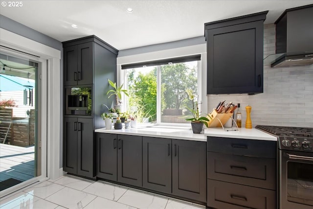 14510 NE 50th St, Vancouver, WA 98682 - kitchen featuring wall chimney range hood, stainless steel range with gas cooktop, decorative backsplash, light countertops, and recessed lighting