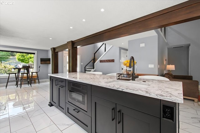 14510 NE 50th St, Vancouver, WA 98682 - kitchen featuring light marble finish floors, stainless steel microwave, light stone countertops, recessed lighting, and open floor plan