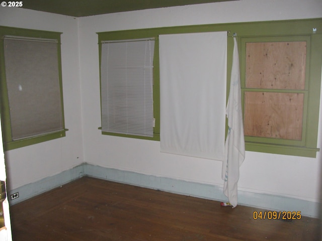 unfurnished room with wood finished floors