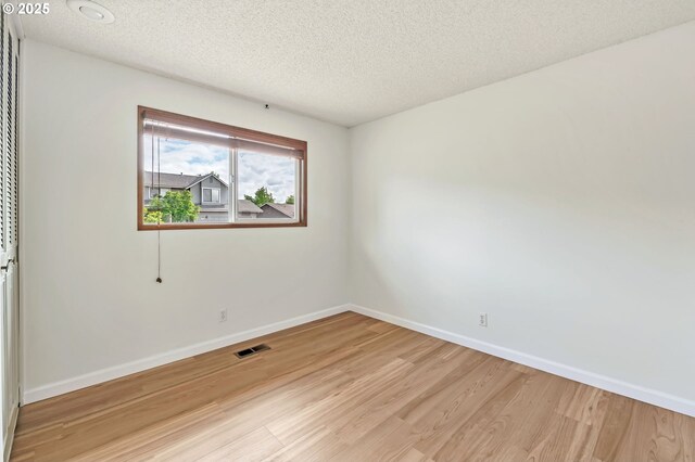 590 Granite Pl, Springfield, OR 97477 - spare room featuring light wood-type flooring and a textured ceiling