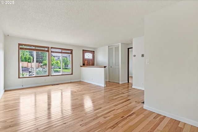 590 Granite Pl, Springfield, OR 97477 - empty room with a textured ceiling, light wood finished floors, and plenty of natural light