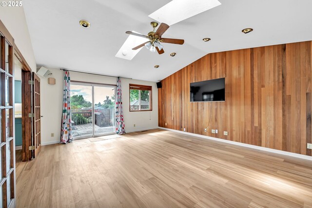 590 Granite Pl, Springfield, OR 97477 - unfurnished living room featuring a skylight, lofted ceiling, a ceiling fan, wood walls, and light wood finished floors