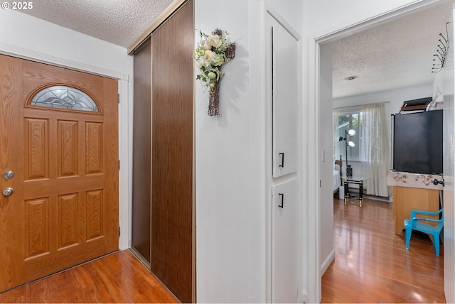 2710 SE 138th Ave Unit 48, Portland, OR 97236 - foyer entrance featuring a textured ceiling and light wood-type flooring