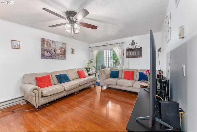 2710 SE 138th Ave Unit 48, Portland, OR 97236 - living area featuring a textured ceiling, wood finished floors, a ceiling fan, and a baseboard heating unit
