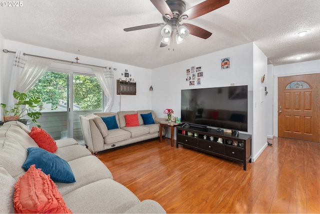 2710 SE 138th Ave Unit 48, Portland, OR 97236 - living room featuring a textured ceiling, light wood-style flooring, and a ceiling fan