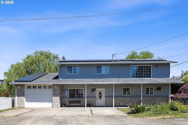 410 W Jefferson St, Carlton, OR 97111 - view of front of property with covered porch, solar panels, a chimney, a garage, and driveway