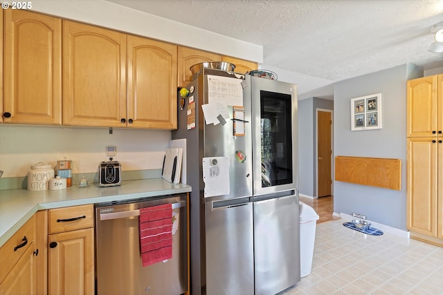 410 W Jefferson St, Carlton, OR 97111 - kitchen featuring light countertops, a textured ceiling, appliances with stainless steel finishes, baseboards, and light brown cabinetry