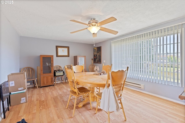 410 W Jefferson St, Carlton, OR 97111 - dining area featuring baseboard heating, wood finished floors, a textured ceiling, ceiling fan, and baseboards