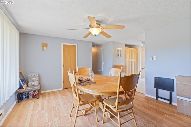 410 W Jefferson St, Carlton, OR 97111 - dining room featuring wood finished floors, a ceiling fan, a textured ceiling, and baseboards