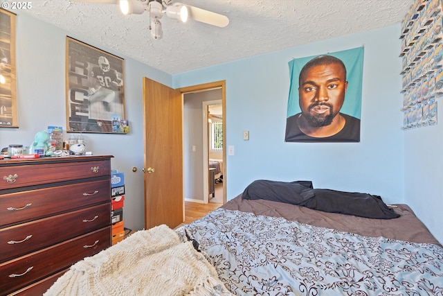 410 W Jefferson St, Carlton, OR 97111 - bedroom featuring a textured ceiling, wood finished floors, and a ceiling fan