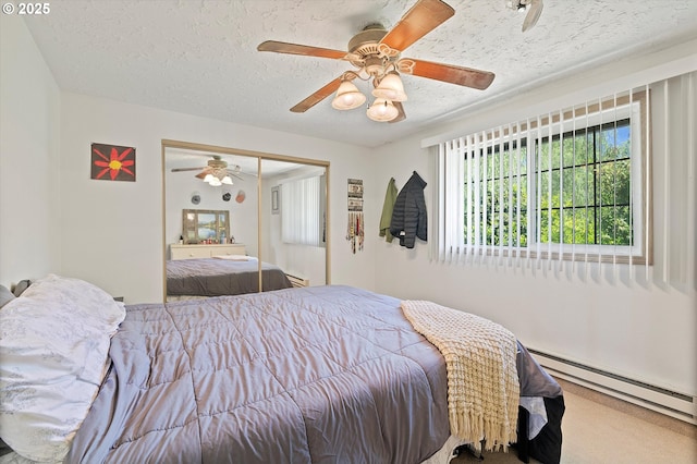 410 W Jefferson St, Carlton, OR 97111 - carpeted bedroom featuring a textured ceiling, a baseboard radiator, ceiling fan, and a closet