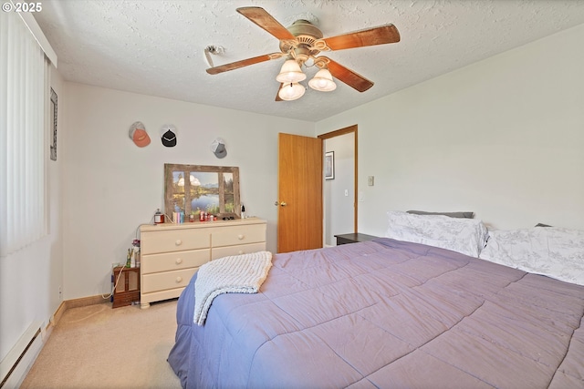 410 W Jefferson St, Carlton, OR 97111 - bedroom featuring a baseboard radiator, light colored carpet, baseboards, a textured ceiling, and a ceiling fan