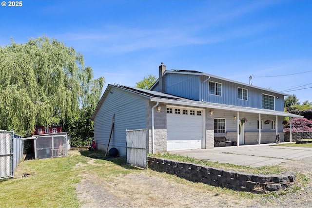 410 W Jefferson St, Carlton, OR 97111 - view of side of home featuring a chimney, concrete driveway, a garage, and a porch