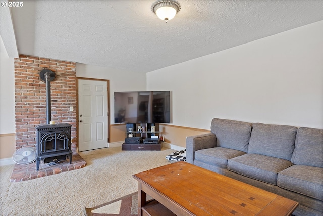 410 W Jefferson St, Carlton, OR 97111 - carpeted living room featuring baseboards, a wood stove, and a textured ceiling