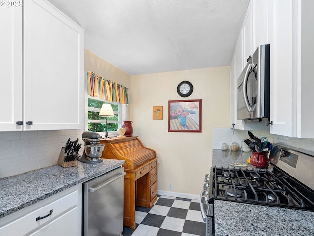 5665 Bonita Rd, Lake Oswego, OR 97035 - kitchen featuring stainless steel appliances, dark flooring, white cabinetry, and tasteful backsplash