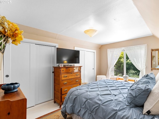 5665 Bonita Rd, Lake Oswego, OR 97035 - bedroom featuring multiple closets and vaulted ceiling