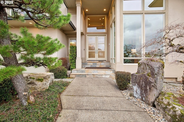 entrance to property with french doors and stucco siding