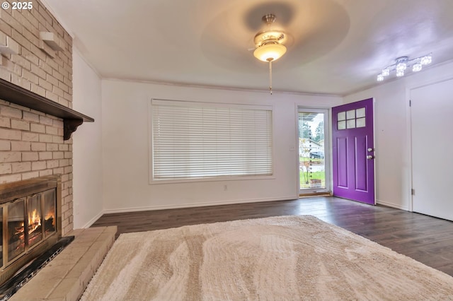 600 NE 144th Ave, Vancouver, WA 98684 - foyer entrance with dark wood-style flooring, a brick fireplace, baseboards, and ornamental molding