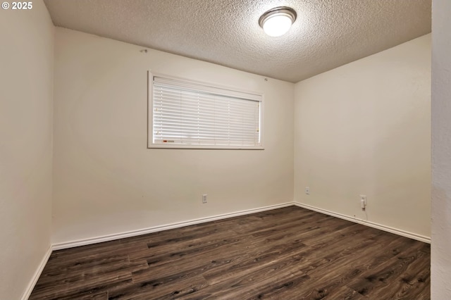600 NE 144th Ave, Vancouver, WA 98684 - spare room featuring dark wood-style flooring, a textured ceiling, and baseboards