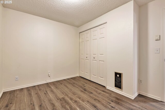 600 NE 144th Ave, Vancouver, WA 98684 - unfurnished bedroom featuring wood finished floors, a textured ceiling, a closet, and baseboards