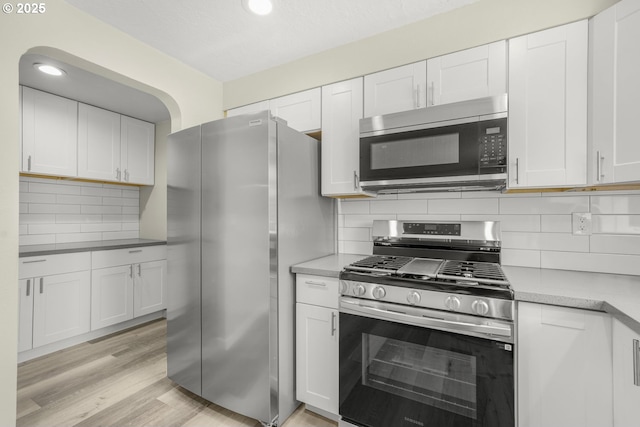 14108 NE 49th St, Vancouver, WA 98682 - kitchen featuring appliances with stainless steel finishes, white cabinets, decorative backsplash, light countertops, and recessed lighting