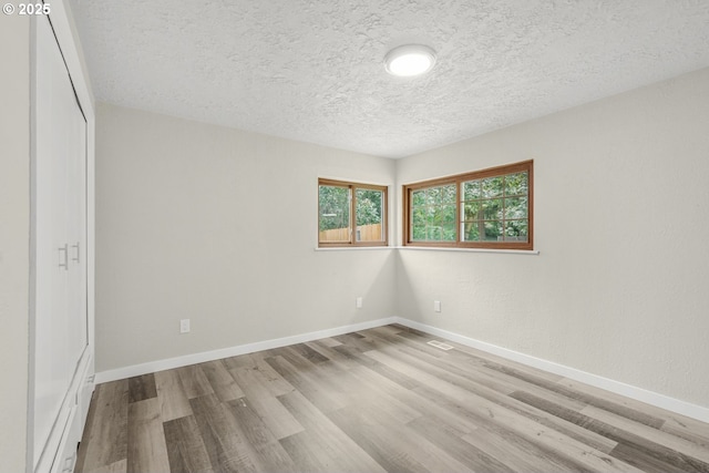 14108 NE 49th St, Vancouver, WA 98682 - unfurnished bedroom featuring wood finished floors, a textured ceiling, baseboards, and a closet