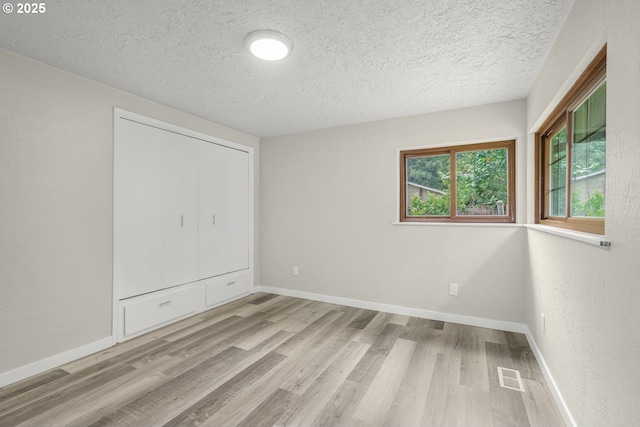 14108 NE 49th St, Vancouver, WA 98682 - unfurnished bedroom with wood finished floors, a textured ceiling, and baseboards