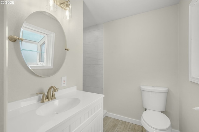 14108 NE 49th St, Vancouver, WA 98682 - bathroom with toilet, vanity, wood finished floors, and baseboards