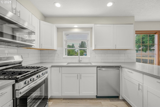 14108 NE 49th St, Vancouver, WA 98682 - kitchen with stainless steel appliances, a sink, tasteful backsplash, white cabinets, and recessed lighting