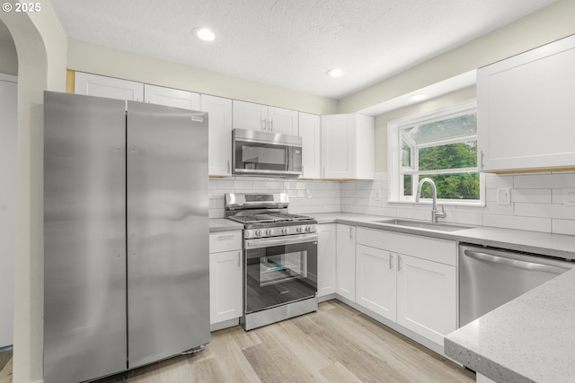 14108 NE 49th St, Vancouver, WA 98682 - kitchen featuring appliances with stainless steel finishes, a sink, white cabinets, recessed lighting, and backsplash