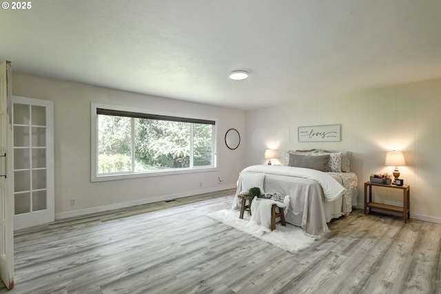 bedroom featuring wood finished floors and baseboards