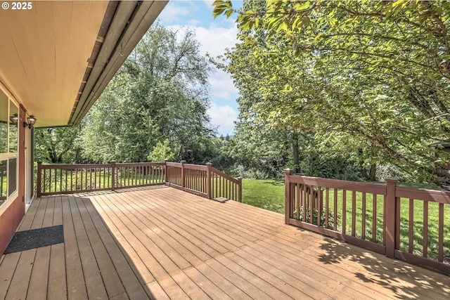 wooden deck with view of wooded area