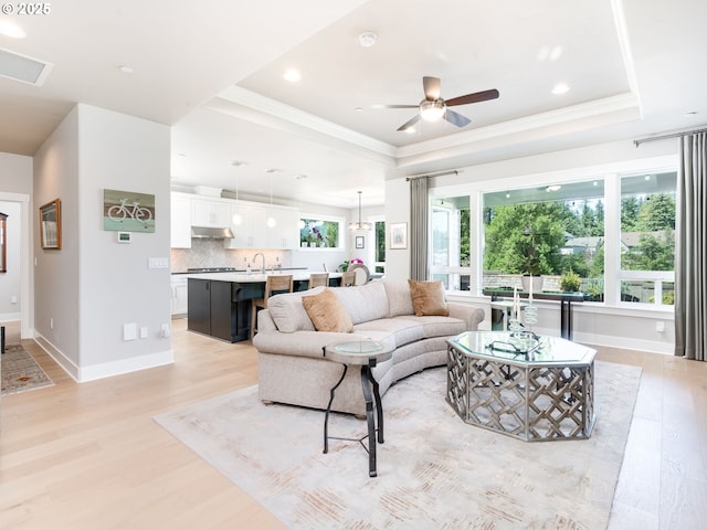 1856 NW Sierra Way, Camas, WA 98607 - living area with a raised ceiling, light wood-type flooring, ceiling fan, recessed lighting, and crown molding