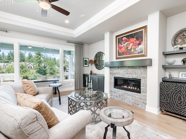 1856 NW Sierra Way, Camas, WA 98607 - living room featuring ornamental molding, wood finished floors, a fireplace, ceiling fan, and a tray ceiling