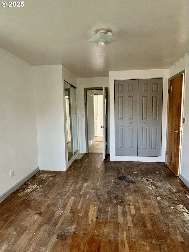 unfurnished bedroom with dark wood-type flooring