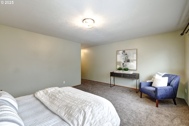 bedroom with a textured ceiling and carpet