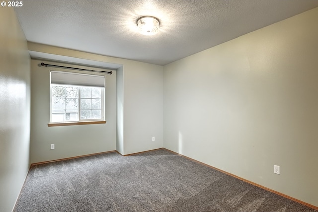 unfurnished room featuring carpet and a textured ceiling