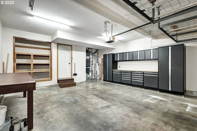 garage featuring a garage door opener and water heater