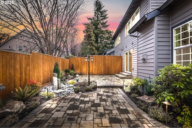 view of patio terrace at dusk