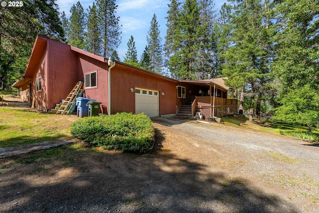 905 Summit Loop, Grants Pass, OR 97527 - view of front of home with stairs, a garage, and dirt driveway