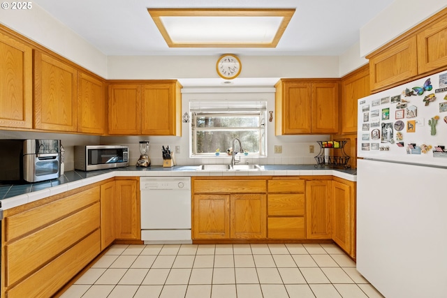 905 Summit Loop, Grants Pass, OR 97527 - kitchen with white appliances, a sink, tile counters, and brown cabinetry