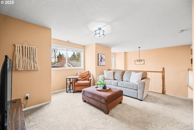 carpeted living room featuring a textured ceiling and baseboards