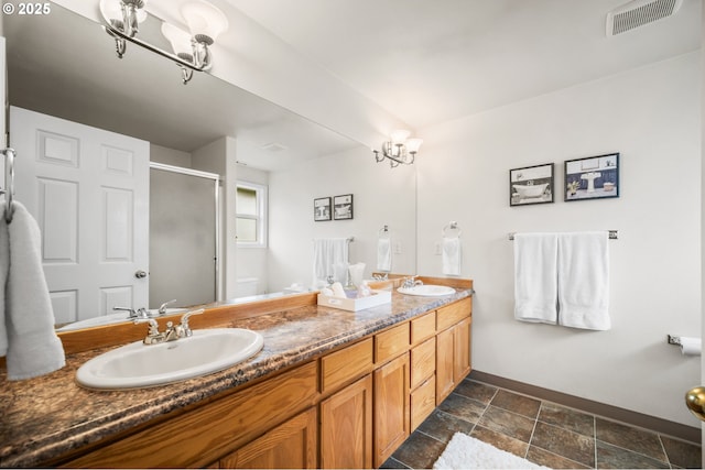 full bath featuring double vanity, a stall shower, visible vents, and a sink