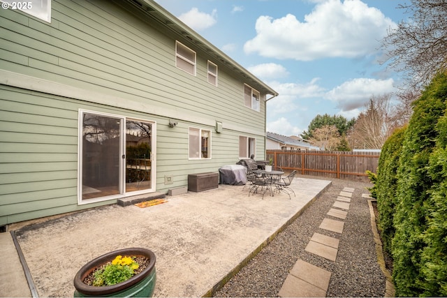 rear view of house with a patio area and a fenced backyard