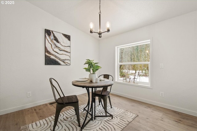662 Cannavina Rd, Carson, WA 98610 - dining space with a chandelier, light wood-style flooring, and lofted ceiling
