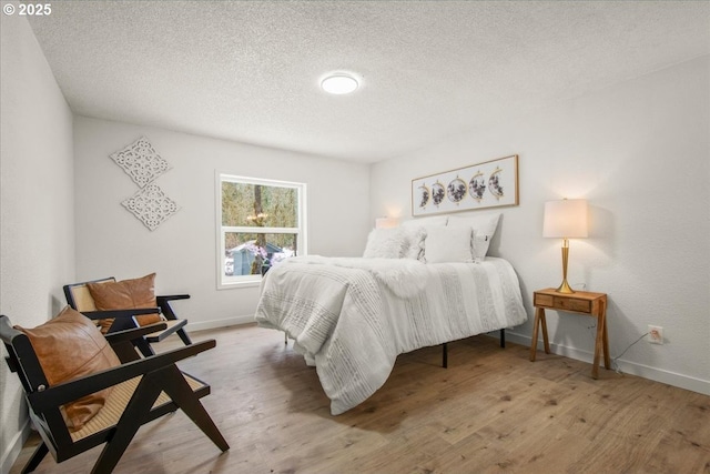 662 Cannavina Rd, Carson, WA 98610 - bedroom with a textured ceiling and wood finished floors